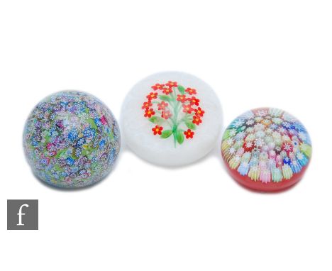 A contemporary Peter McDougall glass paperweight, of domed form, internally decorated with a spray of stylised red flowers wi