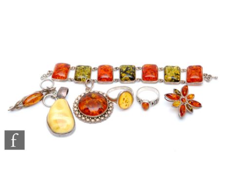 A small parcel lot of assorted silver set Baltic amber jewellery to include a seven panel bracelet, rings, pendants and brooc