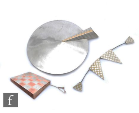 Three pieces of modernist white metal jewellery comprising a large pin of circular form with a stylised arrow, a brooch forme