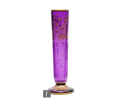 A late 19th Century crystal glass vase attributed to Moser, the sleeve form body with upper rococo scroll work over vertical 