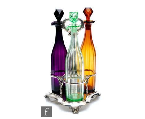 A set of three glass decanters circa 1850, one in amethyst, one in amber and one in pale green, each panel cut with conformin