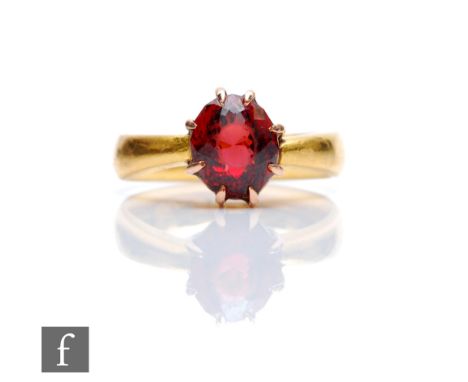 A 22ct hallmarked wedding ring with later set single stone garnet, weight 6.7g, Birmingham 1919. 