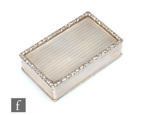 A hallmarked silver rectangular snuff box engine turned decoration within raised foliate borders, weight 124.6g, length 8cm, 