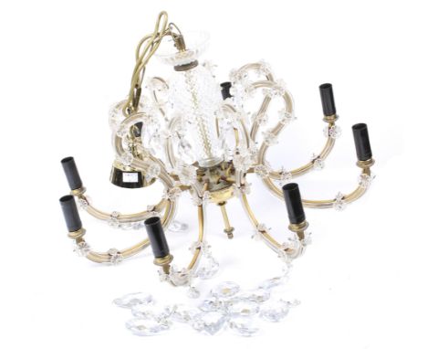 A contemporary eight branch chandelier. With applied glass floral details and droplets, attached to a brass frame and chain, 