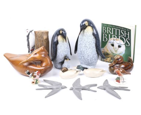 An assortment of bird ornaments. Including composite models of penguins, two ceramic birds signed 'E Roberts', a carved woode