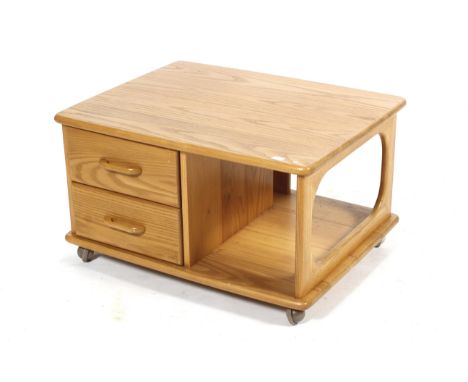 A contemporary light oak coffee table. In the retro style, the lower section with pierced supports and separated into section