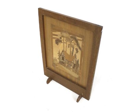 A mid-century parquetry wooden fire screen. Featuring a scene of a Tudor house amongst trees, H61cm