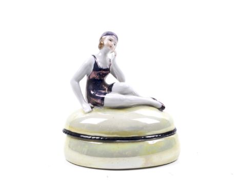 Art Deco lustre trinket box. Modelled with a bather. H11cm Condition Report: Overall in good condition. No obvious chips or r