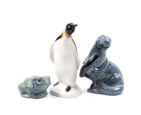 Three mid-century Poole Pottery animal figures. Including a frog, an otter and a penguin. Max. H14cm