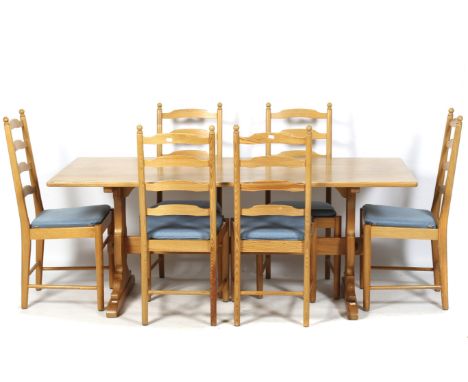 A pine kitchen table and set of six Ercol (blue label) ladderback chairs. Table measurements L182cm x D80cm x H72cm