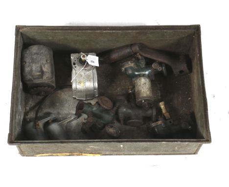 An assortment of Lister stationary engine spares. Including two ignition magnetoes and carburetors.
