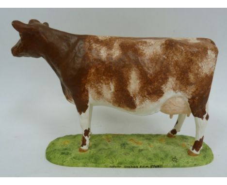 Ceramic figure of a Dairy Shorthorn Cow, 11" long.