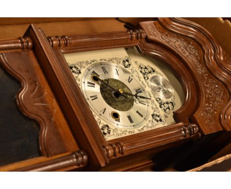 A reproduction mahogany wall clock