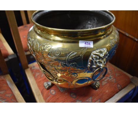 A brass planter having vine decoration and lion mask handles