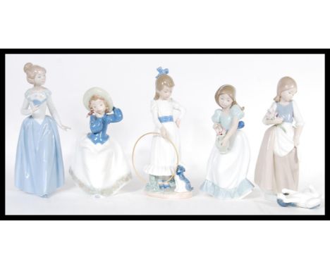 A collection of five Nao porcelain figurines to include a girl with a jug full of flowers no. 01001, a lady with a fan 00402,