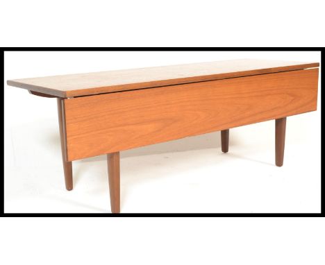 A retro 20th Century teak wood gate leg flap extendable coffee table, single leaf raised on tapering shaped supports. Measure