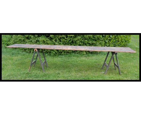 A large vintage 20th century wooden industrial fair / fete trestle ( dining ) table. Of very large, long form with planked wo