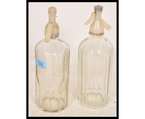 Two vintage retro 20th Century faceted glass soda syphons one by Schweppes and the other for WT Hoskins and Son Brixham.