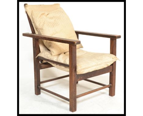 A 1920's Art Deco Morris fire side children's chair, having adjustable ladder backrest, constructed with a mahogany frame wit