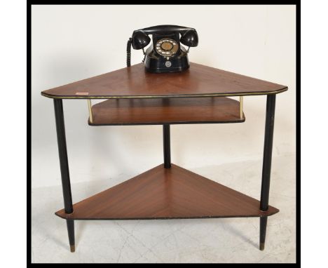 A retro 20th Century two tiered corner telephone table together with a vintage Belgium made Bell telephone. Measures 60 cm hi