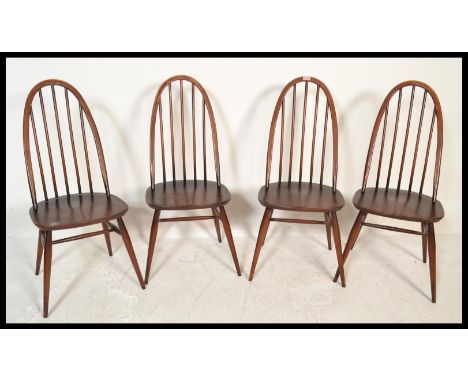 A set of four vintage 20th Century Ercol elm and beech 'Windsor' hoop back dining chairs, model 370, railed backs raised on t