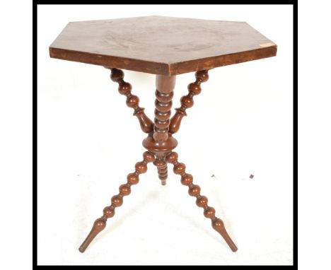 An early 20th Century Mahogany Gypsy occasional table raised on bobbin turned tripod base with hexagonal table top.