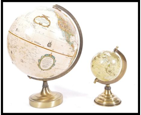 A graduating pair of vintage 20th Century desk top globes raised on circular brass bases. Measures 41 cm high x 30 cm diamete