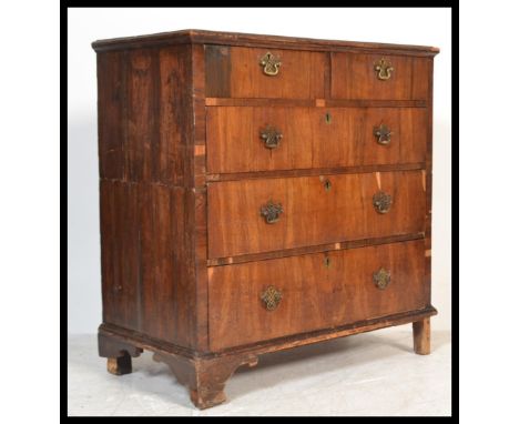 A 17th century walnut Queen Anne 2 part chest of drawers. The chest with pierced brass  handles and escutcheons having bracke
