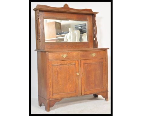 A late 19th century Arts &amp; Crafts oak mirror back sideboard raised on bracket feet. Bevelled mirror panel top with shaped