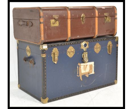 A good collection of vintage luggage to include a group of Edwardian ledger boxes, a canvas bound steamer trunk, and a large 