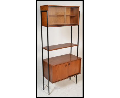 A vintage retro 20th Century teak wood Avalon modular system having an arrangement of shelves and cupboards supported on ebon