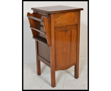 An early 20th Century walnut bedside table compendium of unusual form having a magazine rack to side with book shelf section 