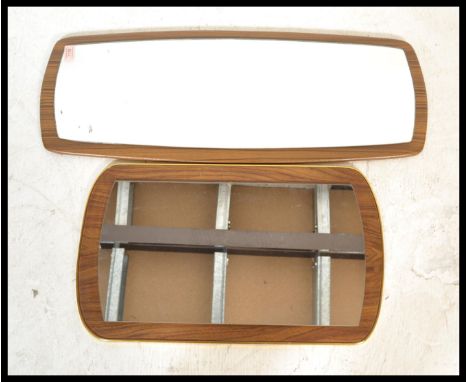 Two vintage retro 20th Century frameless wall mirrors of oblong form. Central mirror panels on wooden backs.