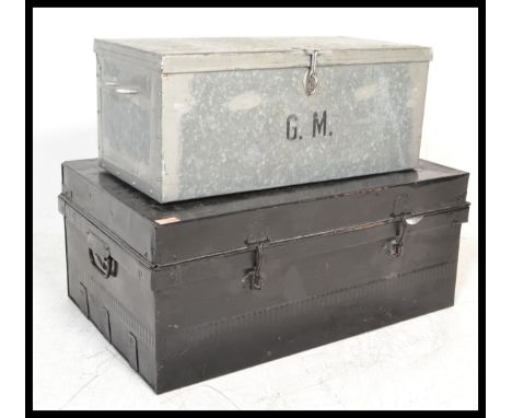 An early 20th Century ebonised metal deed trunk of rectangular form together with another similar.&nbsp;