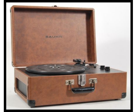 A contemporary Ferguson record player deck having USB compatibility. Hinged lid opening to reveal record deck. Measures 19cm 