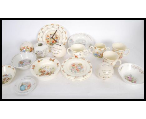 A collection of Royal Doulton ' Bunnykins ' ceramics to include small plates, mugs, money boxes, a twin handled mug, a clock 