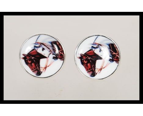 A pair of stamped 925 silver cufflinks set with round enamelled panels depicting horses. Weight 10.4g.&nbsp;