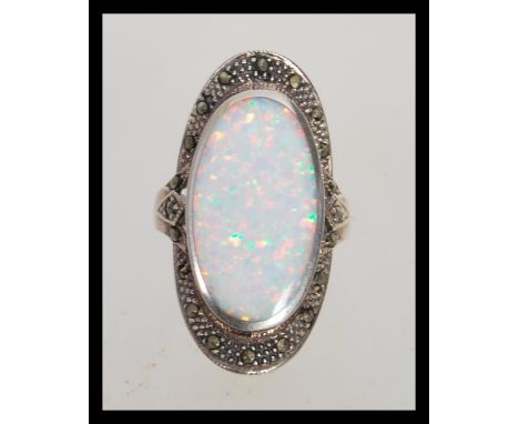 A stamped 925 silver Art Deco style ring having a central opal panel and marcasite accent stones. Weight 6.5g. Size N.