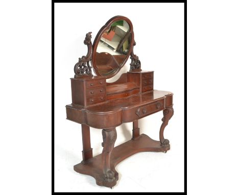 A 19th Century Victorian mahogany Duchess dressing table raised on scrolled legs with oval swing mirror flanked by twin trink