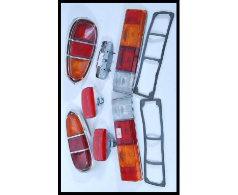 Two pairs of 20th century vintage tail lights. A pair of Fomoco rear lights unit STB62/120 having chrome case and along with 