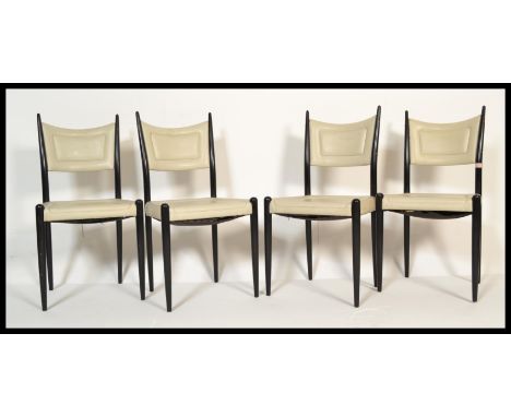 A set of four vintage 20th Century retro Ernest Gomme G-Plan / G Plan dining chairs raised on tapering ebonised legs with whi