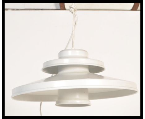 A vintage retro light fixture in the manner of Poul Henningsen having a two step UFO type shape in a white colourway. Measure