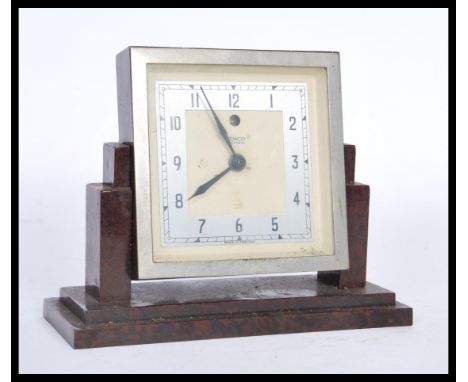 A 1930's Art Deco mark V electric clock by Temco, having a white enamel dial with silver chapter ring and faceted hands, set 