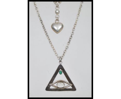 Two silver necklaces to include a pendant necklace with a triangular pendant with an eye design set with white and green cabo