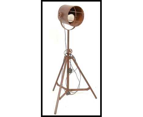 A vintage industrial floor standing adjustable spot light, raised on a metal tubular tripod frame. Measures 100 cm high.