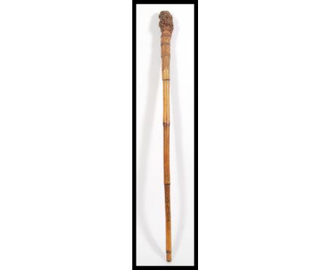 A 19th Century Victorian bamboo root walking stick cane having a tapering bamboo shaft with large bulbous bamboo root handle.