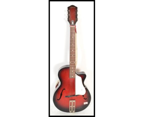 A vintage 20th Century 1950's Egmona six string guitar musical instrument having a flame sunburst body with mother of pearl f