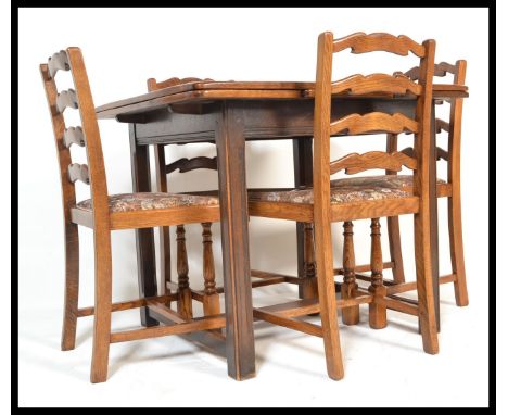 A vintage mid 20th Century Ercol 1940's stained beech draw leaf table along with a set of four ladderback dining chairs.