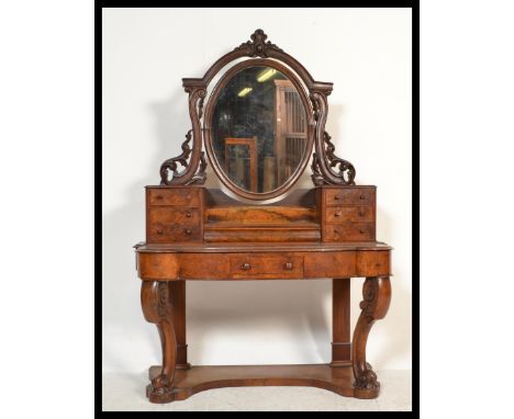 A 19th Century Victorian burr walnut Duchess dressing table raised on scrolled legs with oval swing mirror flanked by twin tr