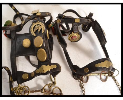 A good group of early 20th Century horse leather tacks and mounts having various horse brasses including enamel examples.